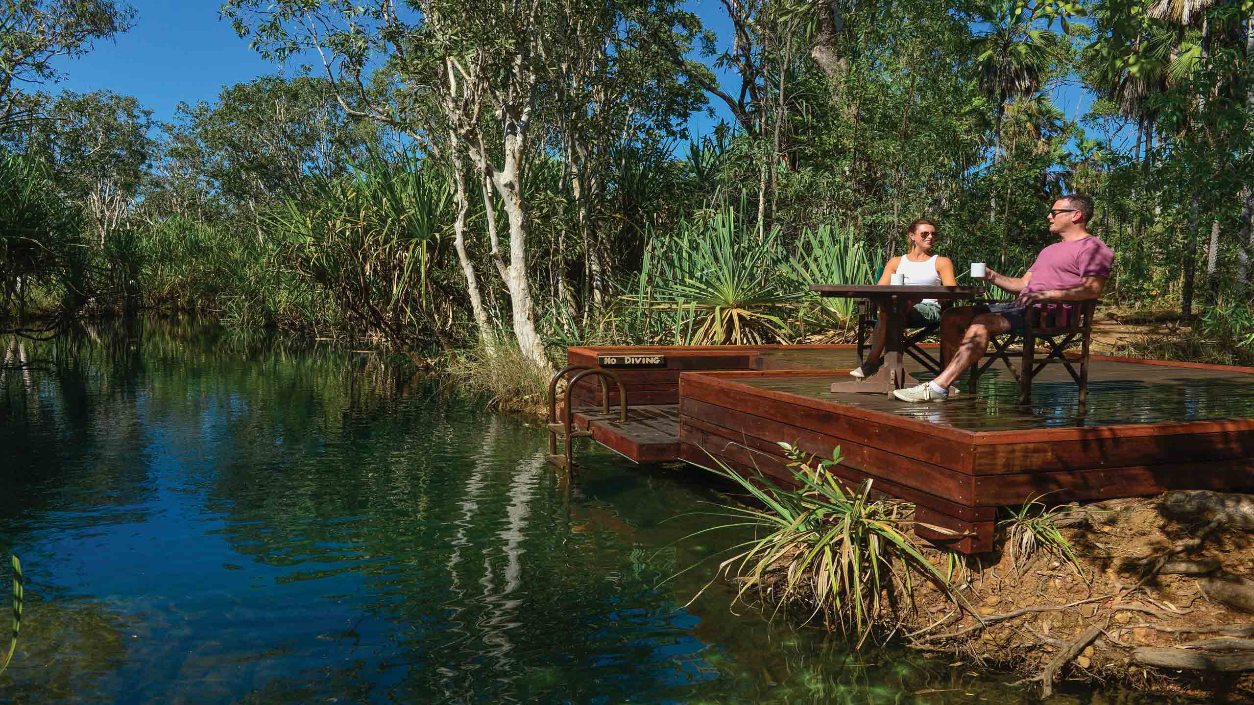 mitchell-falls-wilderness-lodge-waterhole-couple-on-deck