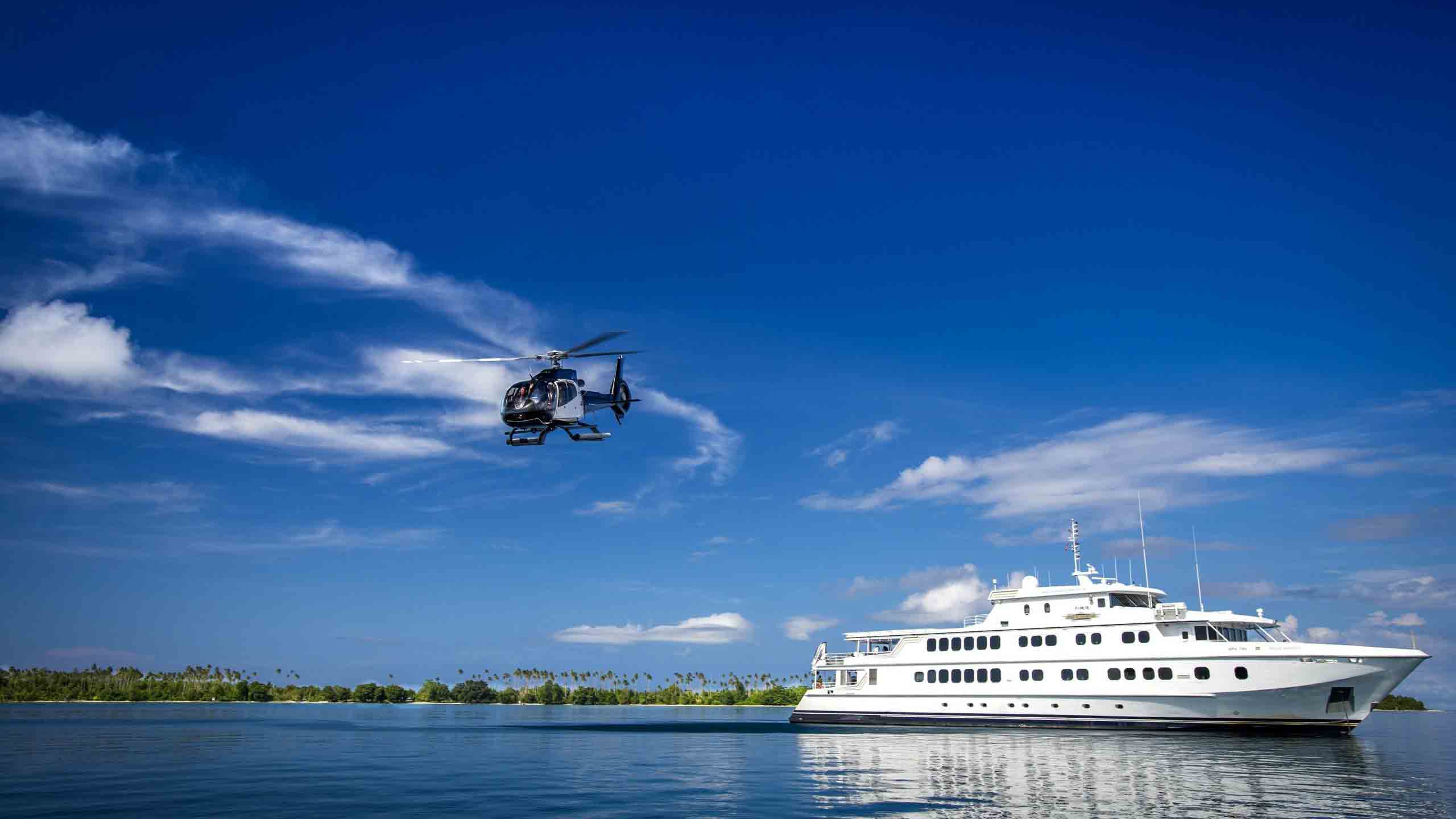 true-north-cruise-australia-papua-helicopter-flying-near-ship